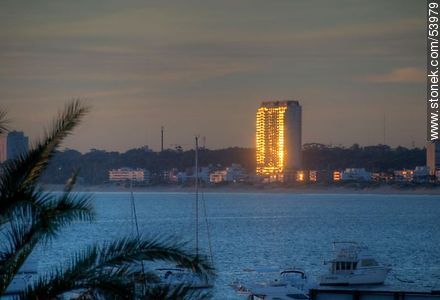 Reflection of the setting sun in the Torre Jardin - Punta del Este and its near resorts - URUGUAY. Photo #53979