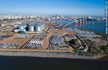 Aerial photo of the port. Silos and imported vehicles.  Row of trucks with grains. - Department of Montevideo - URUGUAY. Photo #66121