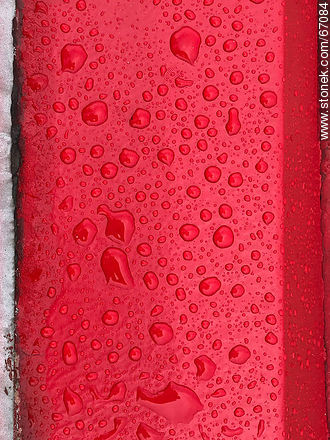 Water drops on a bright red background -  - MORE IMAGES. Photo #67084