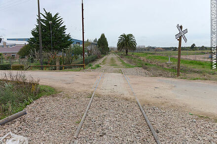 Section of railroad only at the intersection with a street - Department of Canelones - URUGUAY. Photo #69859