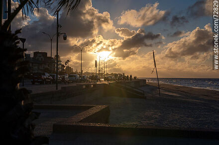The sun through the clouds in a winter sunrise on the promenade - Department of Montevideo - URUGUAY. Photo #72829