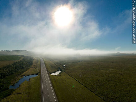 Aerial view of route 8 with mist and sun in front of it - Department of Treinta y Tres - URUGUAY. Photo #78352