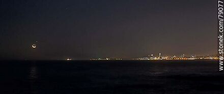 The new moon about to set in the sea in front of the port of Montevideo - Department of Montevideo - URUGUAY. Photo #79077