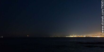 The new moon about to set in the sea in front of the port of Montevideo - Department of Montevideo - URUGUAY. Photo #79085