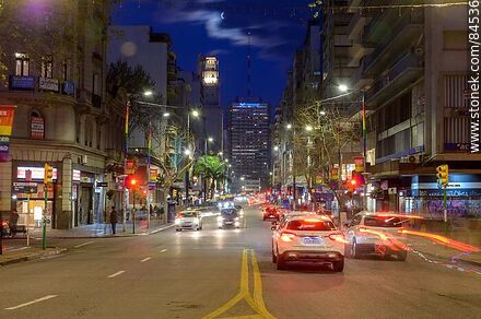 18 de Julio Avenue. Gaucho Tower. Trail of lights left by the traffic at dusk. The full moon - Department of Montevideo - URUGUAY. Photo #84536