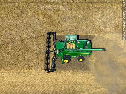 Aerial view of a combine harvester harvesting and threshing barley - Rio Negro - URUGUAY. Photo #85632