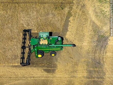 Aerial view of a combine harvester harvesting and threshing barley - Rio Negro - URUGUAY. Photo #85630