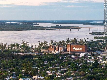 Aerial view of the city of Paysandu at sunset. Fábrica Norteña, Uruguay river and bridge to Colón (ARG.) - Department of Paysandú - URUGUAY. Photo #85901